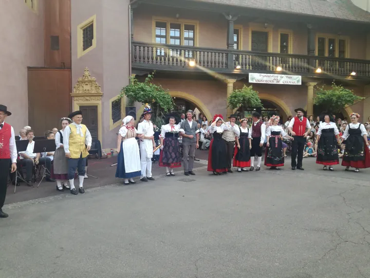 Folklore dancing in the evening at Colmar, Alsace (France)